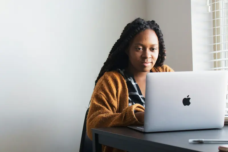 Software engineer planning work at a laptop in a bright office