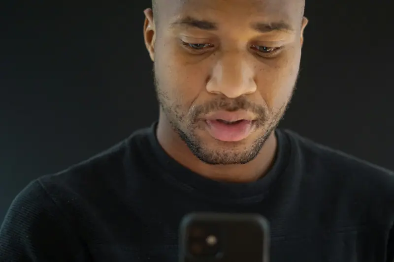 Man looking at a mobile app on his smartphone